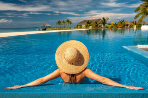 Woman with hat at beach pool in Maldives